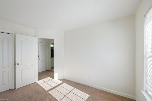 unfurnished bedroom featuring light colored carpet