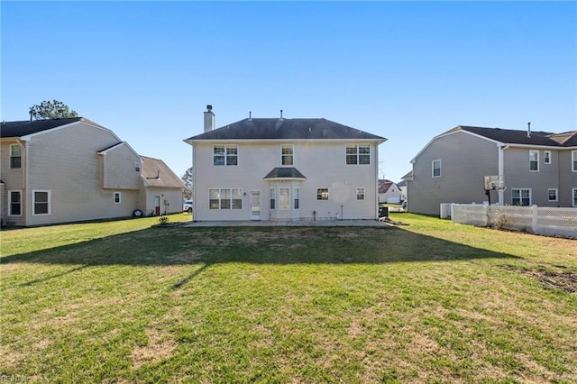 rear view of house with a yard and a patio area