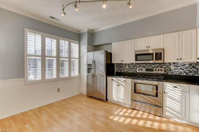 kitchen with crown molding, light hardwood / wood-style floors, white cabinets, and appliances with stainless steel finishes