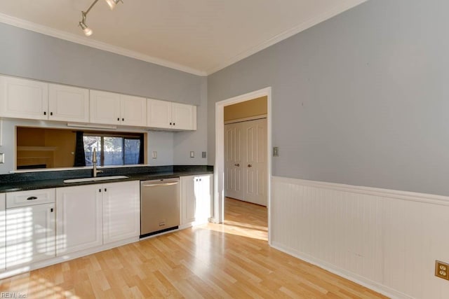 kitchen featuring sink, white cabinets, stainless steel dishwasher, crown molding, and light wood-type flooring