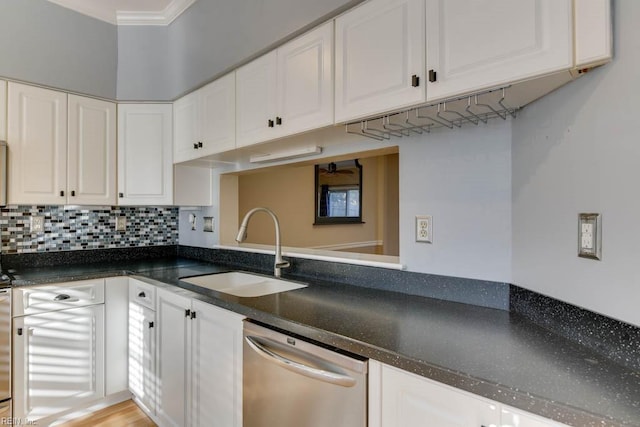 kitchen featuring dishwasher, sink, white cabinets, and decorative backsplash