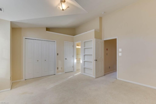 unfurnished bedroom with light carpet and high vaulted ceiling