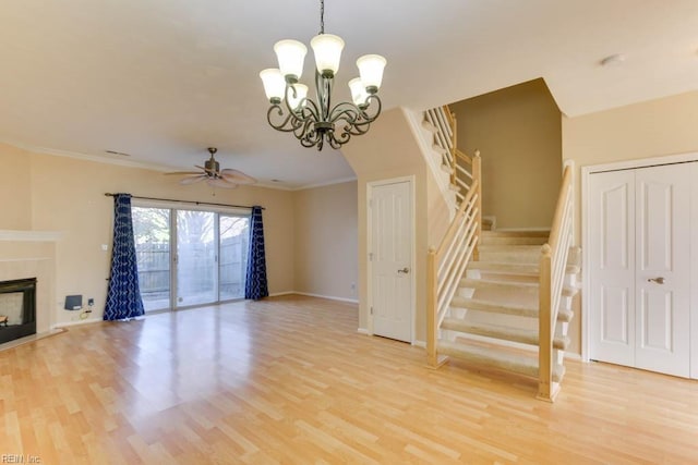 unfurnished living room with ornamental molding, light hardwood / wood-style floors, and ceiling fan