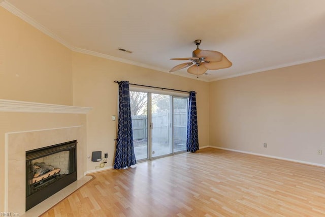 unfurnished living room featuring ceiling fan, ornamental molding, and light wood-type flooring