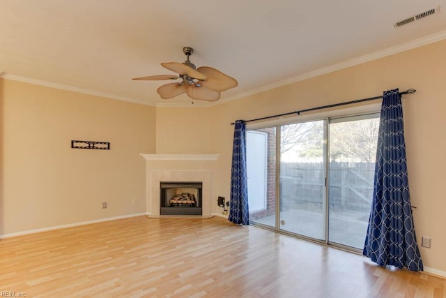 unfurnished living room with hardwood / wood-style flooring, ceiling fan, and ornamental molding