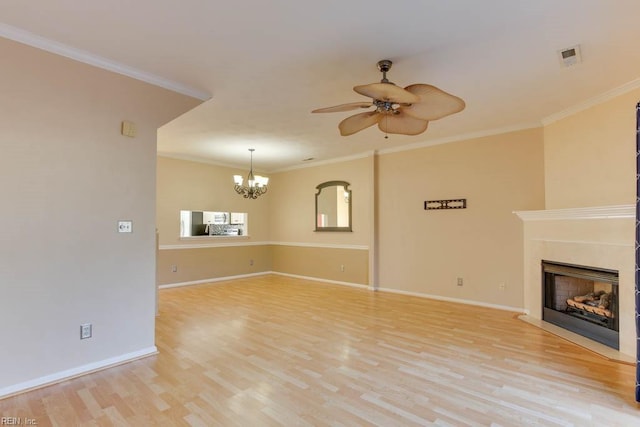 unfurnished living room featuring crown molding, ceiling fan with notable chandelier, and light hardwood / wood-style floors