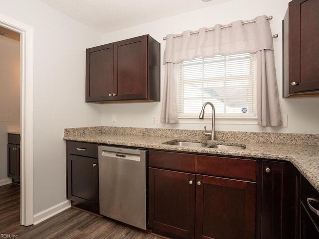 kitchen featuring dark hardwood / wood-style floors, sink, stainless steel dishwasher, dark brown cabinetry, and light stone countertops