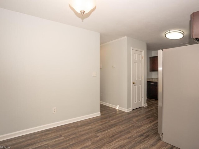 empty room with dark hardwood / wood-style flooring