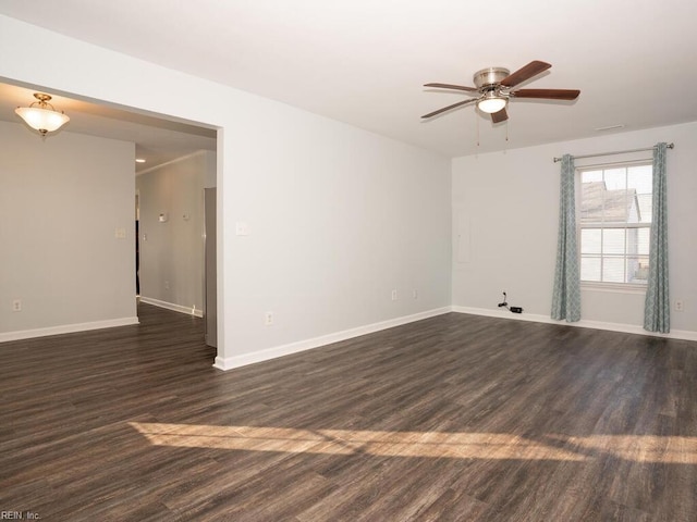 unfurnished room featuring dark wood-type flooring and ceiling fan