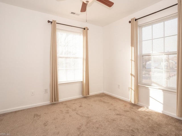 carpeted spare room with ceiling fan