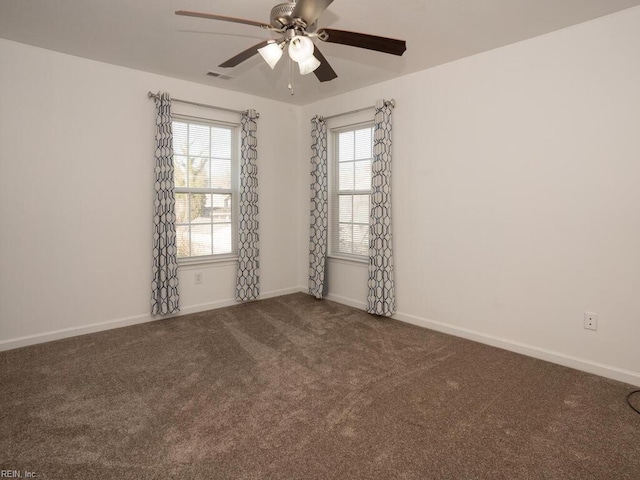 carpeted spare room with ceiling fan