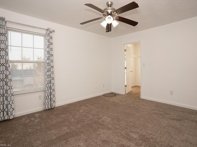 carpeted spare room with ceiling fan