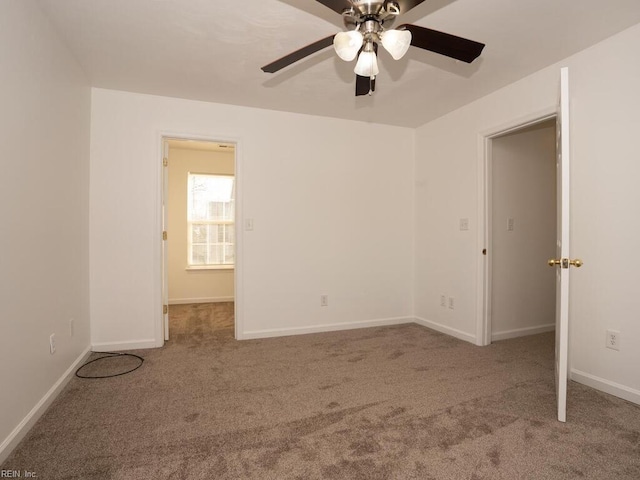 empty room featuring ceiling fan and carpet flooring