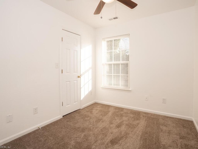 spare room featuring ceiling fan and carpet floors