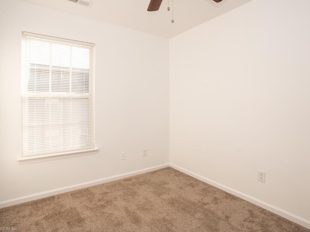 spare room featuring carpet floors and ceiling fan