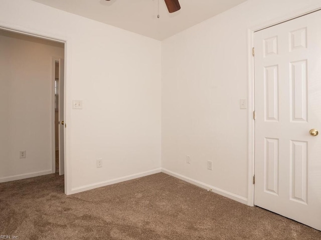 spare room with carpet and ceiling fan