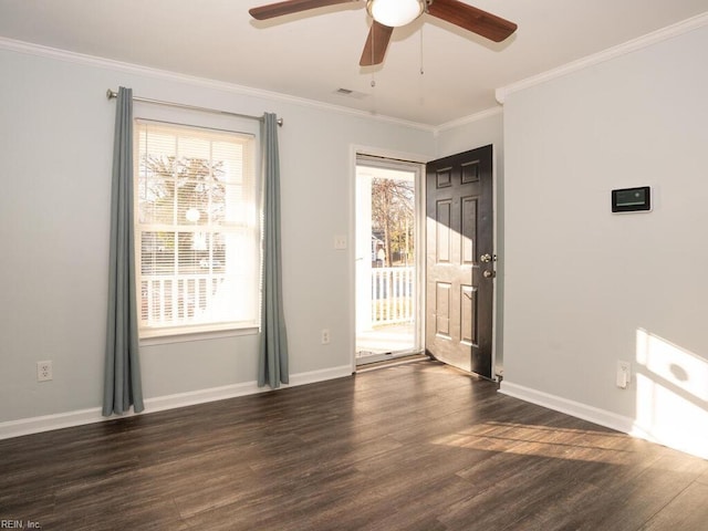 empty room featuring ceiling fan, ornamental molding, a healthy amount of sunlight, and dark hardwood / wood-style flooring