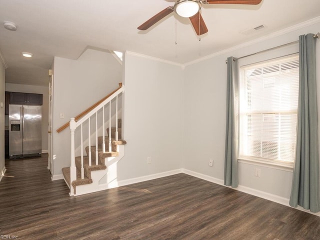 empty room featuring crown molding, dark hardwood / wood-style floors, and ceiling fan