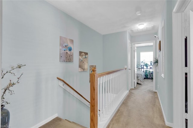 hallway with light colored carpet