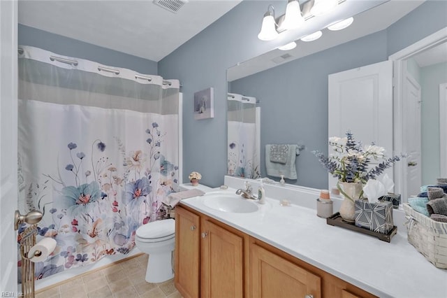 bathroom with vanity, walk in shower, and toilet