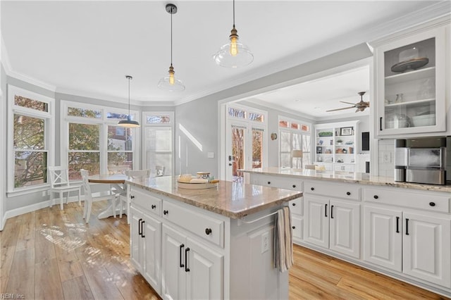 kitchen featuring white cabinetry and pendant lighting