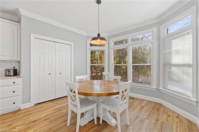 dining room featuring ornamental molding and light hardwood / wood-style floors