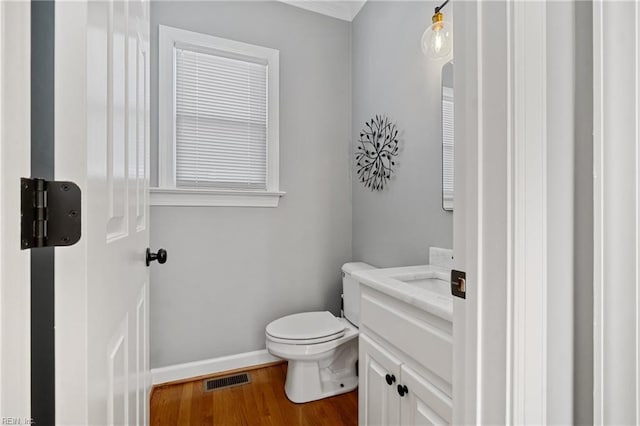 bathroom featuring hardwood / wood-style flooring, vanity, and toilet