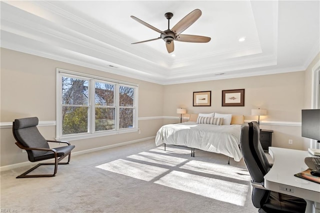 bedroom featuring light carpet, ornamental molding, a raised ceiling, and ceiling fan