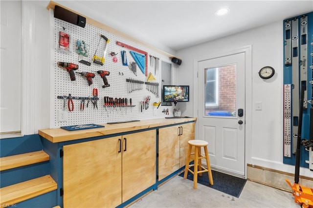 bar featuring butcher block counters and a workshop area