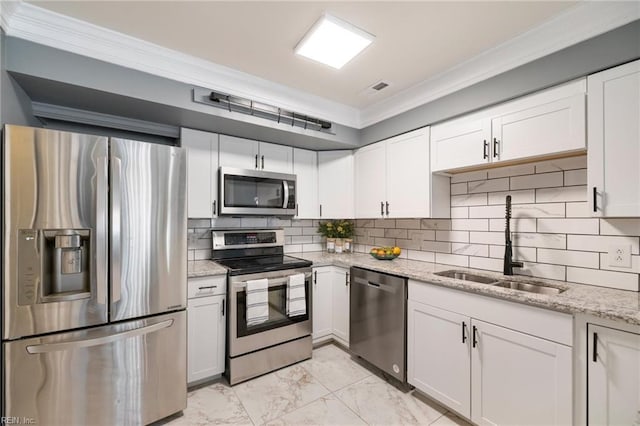 kitchen with white cabinetry, appliances with stainless steel finishes, sink, and decorative backsplash