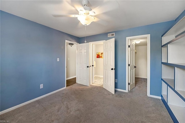 unfurnished bedroom featuring ceiling fan and dark colored carpet