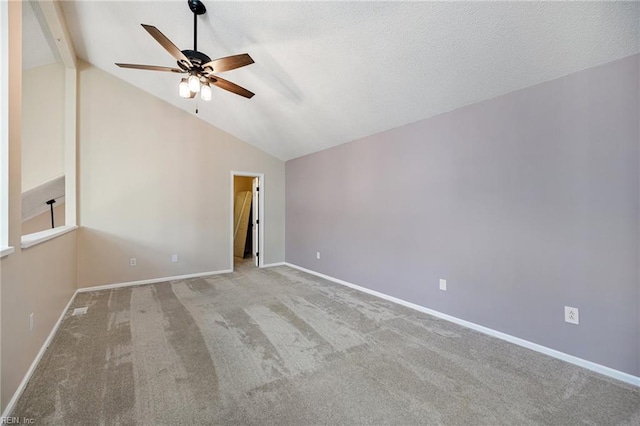 carpeted spare room with lofted ceiling with beams and ceiling fan