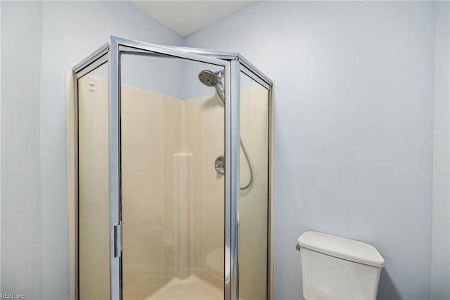 bathroom with toilet and walk in shower