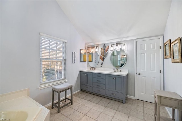 bathroom featuring vanity and lofted ceiling