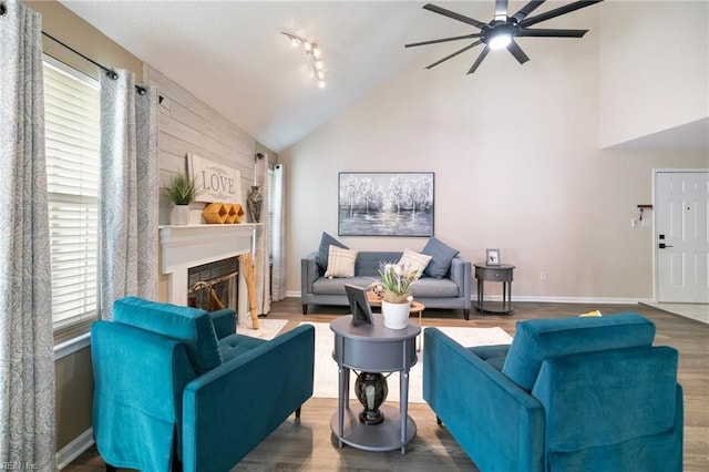 living room featuring ceiling fan, lofted ceiling, hardwood / wood-style floors, and a wealth of natural light