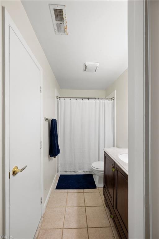 bathroom featuring tile patterned flooring, vanity, and toilet