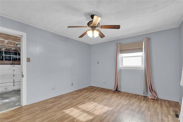 empty room featuring crown molding, ceiling fan, and light hardwood / wood-style floors