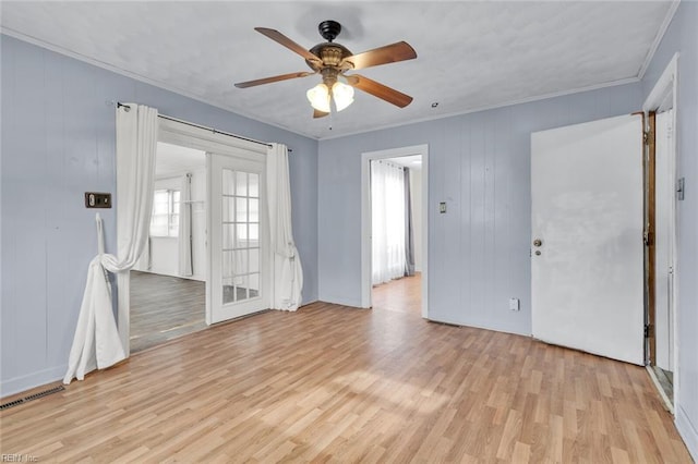 empty room with crown molding, ceiling fan, and light hardwood / wood-style floors