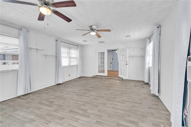 unfurnished living room featuring light hardwood / wood-style floors, french doors, and ceiling fan