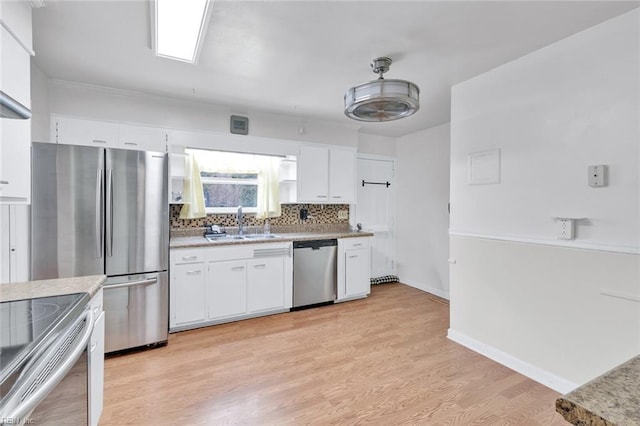 kitchen featuring sink, light hardwood / wood-style flooring, stainless steel appliances, and white cabinets