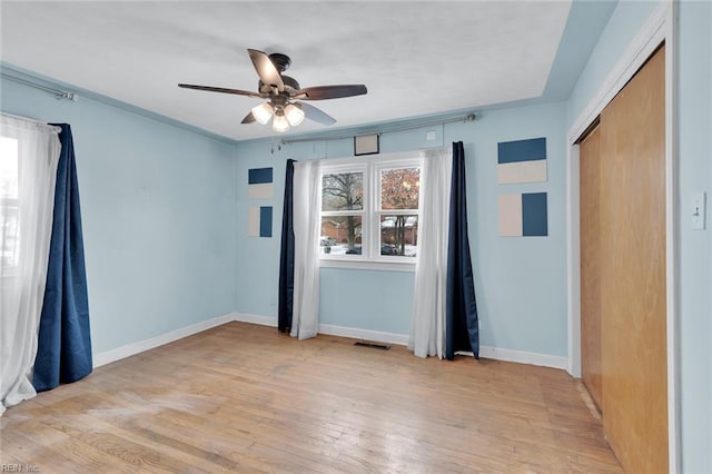 empty room featuring ceiling fan and light hardwood / wood-style floors