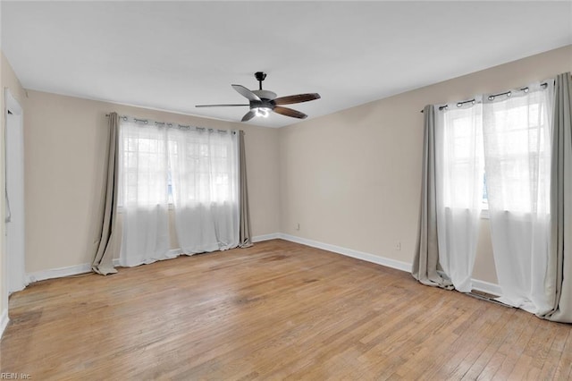 empty room with light hardwood / wood-style flooring and ceiling fan