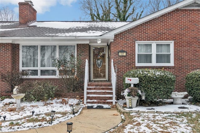 view of snow covered property entrance