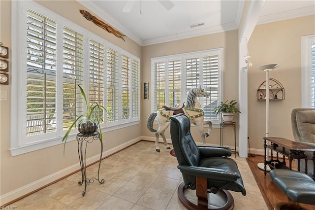 interior space featuring crown molding, ceiling fan, and light tile patterned floors