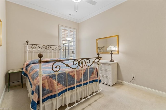 carpeted bedroom featuring crown molding and ceiling fan