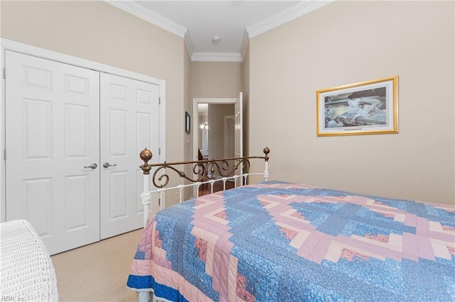 carpeted bedroom featuring ornamental molding and a closet