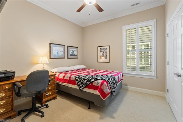 carpeted bedroom with crown molding, ceiling fan, and a closet