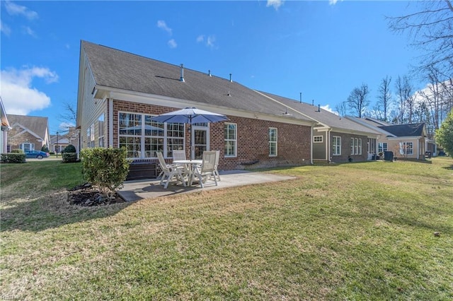 back of house featuring a patio and a lawn