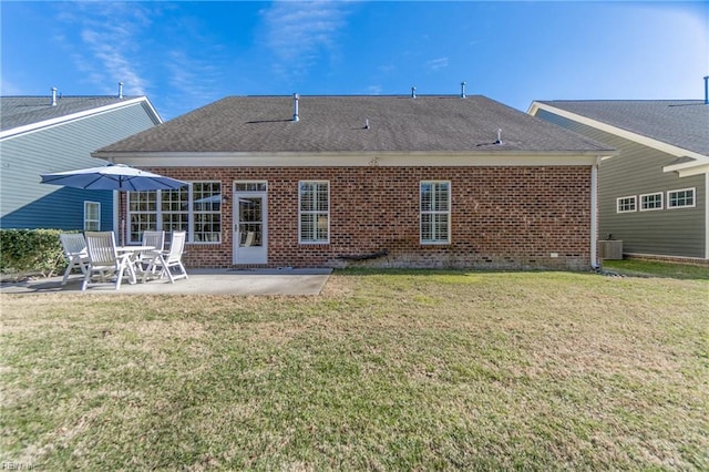 back of property with central air condition unit, a patio, and a lawn