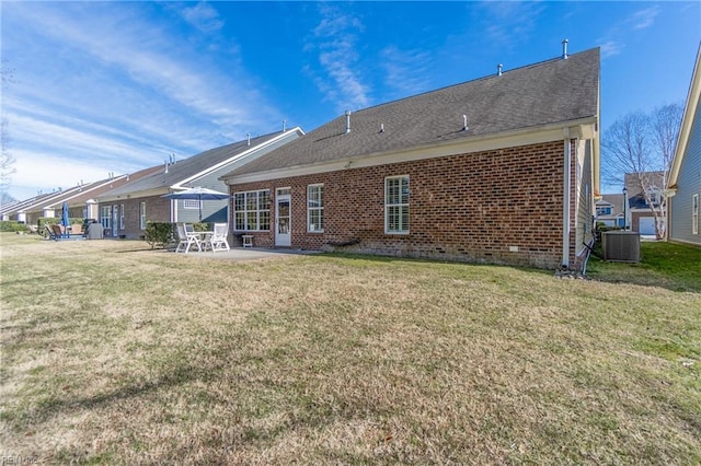 back of property with a yard, central AC, and a patio area